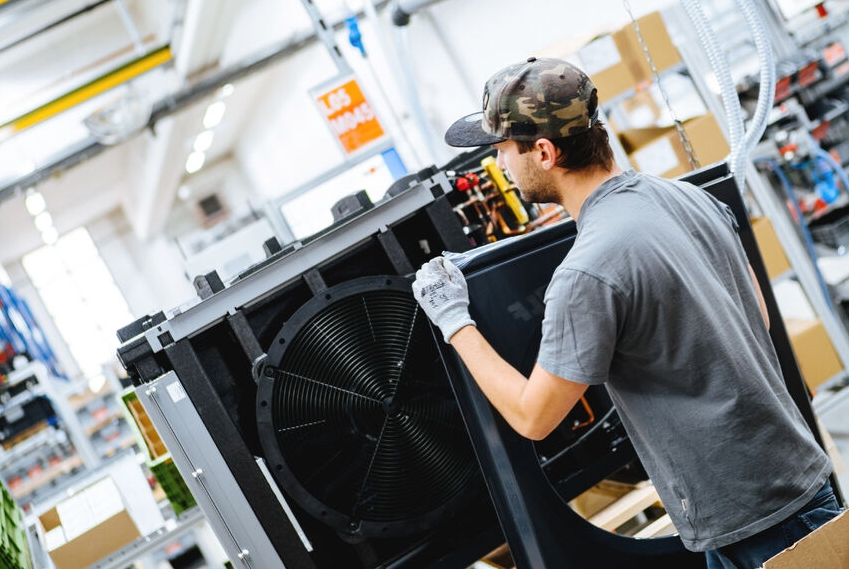 Worker in a heat pump factory